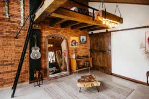 A room with a brick wall and a wooden ceiling